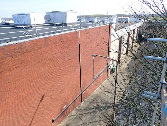 A large wall with roof repairs in progress