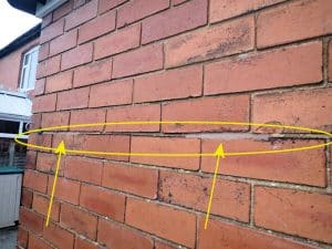 View of old corroding wall ties fixed by isolation method