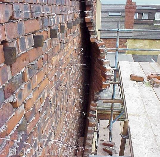 A cavity wall tie failure caused by wall tie corrosion.