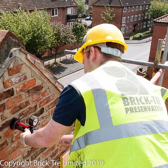 A Brick-Tie wall tie installer checking his work on a gable in York