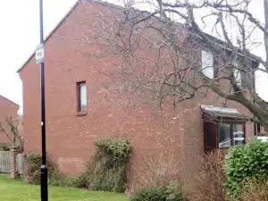 A timberframe house with very rusty wall ties