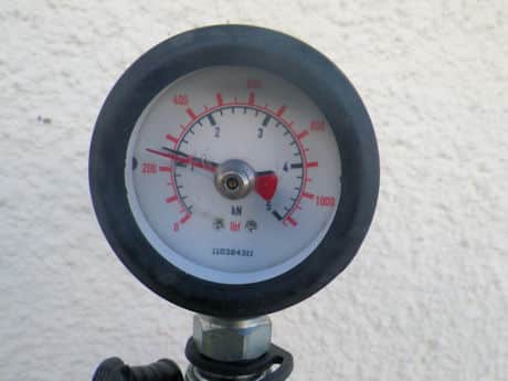 A test gauge showing tensile load on a remedial wall tie in a concrete wall of an easi form house