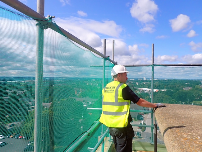 Man looks out from scaffold at height in Leeds