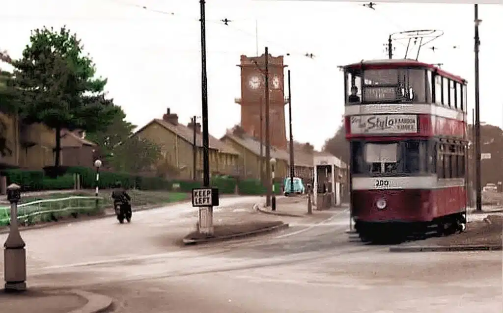 A tram passing a clock tower in Leeds