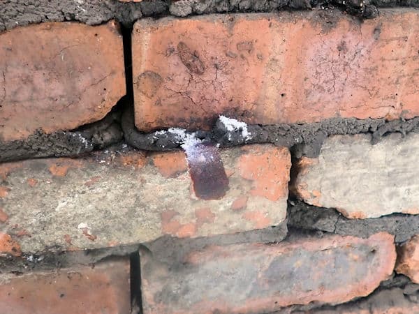 One of the many wall ties which failed due to corrosion. It has snapped at the end where the outer skin of brick was connected