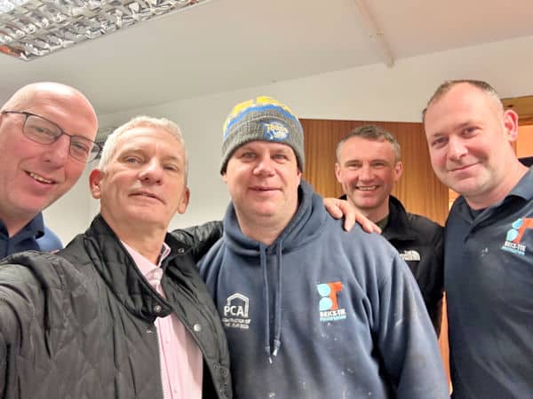 expert wall tie installer Craig Tarbotton celebrates with his team