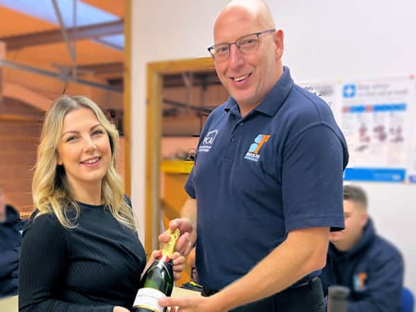 Sian Hamilton receives a bottle of fizz as David Gill welcomes her to the board of Brick-Tie Limited