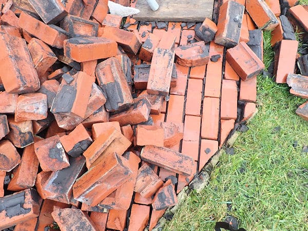 A collapsed section of house wall where wall ties have corroded leading to wall tie failure - in Yorkshire